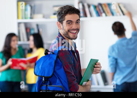 Smiling male student espagnol avec groupe d'étudiants de l'université de la bibliothèque Banque D'Images