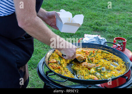 Une grande poêle de paella aux fruits de mer d'être servi en plein air Banque D'Images