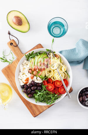 Bol déjeuner cétogène : courgette renforts spiralés avec avocat, tomate, fromage feta, olives, lardons Banque D'Images