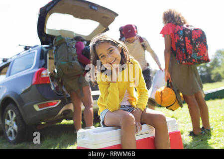 Portrait of smiling girl camping en famille, déchargement location Banque D'Images