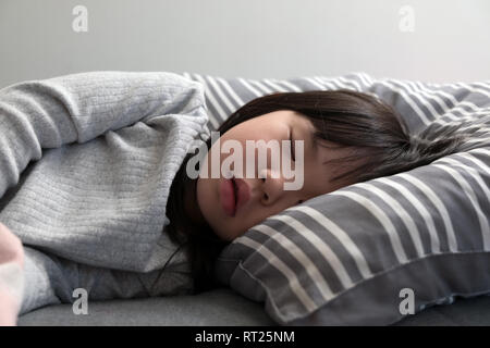 Enfant girl sleeping on bed Banque D'Images