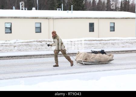 Un soldat du 1er Bataillon 21e Régiment d'infanterie, Schofield Barracks, Virginia, des expériences du remorquage d'un traîneau Ahkio, plein de matériel de survie par temps froid par temps froid, au cours de formation de base Elmendorf-Richardson Inscrivez-vous, en Alaska, le 26 janvier 2019. Avec le 1er Bataillon de parachutistes, 501st Parachute Infantry Regiment d'infanterie, 4e Brigade Combat Team Banque D'Images