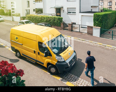 PARIS, FRANCE - JUN 23, 2017 : Courier à marcher en direction de La Poste de livraison pour le van jaune à l'heure de livraison colis Colis - vue aérienne Banque D'Images