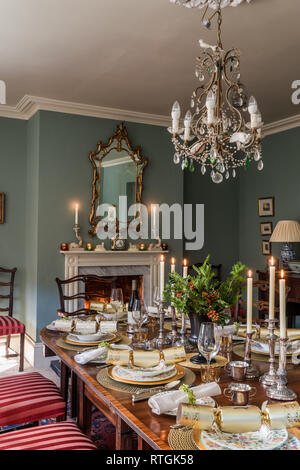 Table à manger en acajou avec des chaises capitonnées de Regency stripe avec cheminée en anglais Banque D'Images