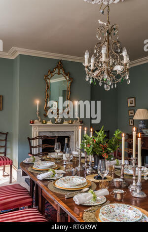 Table à manger en acajou avec des chaises capitonnées de Regency stripe avec cheminée en anglais Banque D'Images