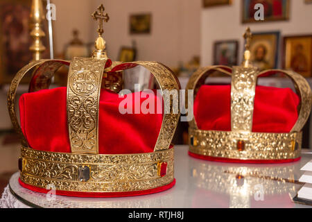 Couronnes d'or de mariage prêts pour la cérémonie du mariage dans l'église orthodoxe serbe. Banque D'Images