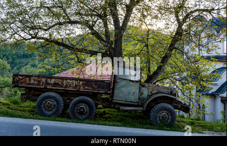 Un vieux camion militaires abandonnés, laissés à pourrir dans l'herbe, mais la résistance à la dent de temps, grandes roues, et corrosifs métal. Serbie Banque D'Images