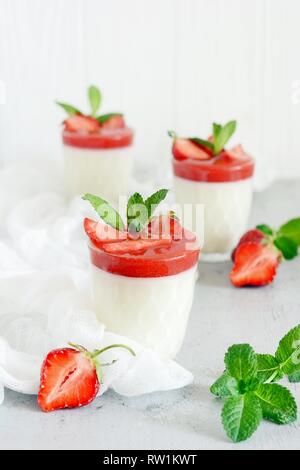 Panakota dessert italien 118 coolies, de baies fraîches et de menthe sur fond blanc avec des ombres. Lait Crème dessert dans un verre d'offres Banque D'Images