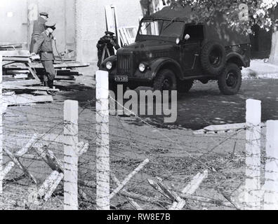 La nouvelle "arme" des communistes dans la guerre froide Berlin Est-ouest est l'appareil photo. Après des semaines de laisser tomber ses photographies prises à partir de l'Ouest, les communistes, au début du mois, ont commencé à tirer des photos eux-mêmes à travers la ligne. Toujours en vue, les photographes semblent tenter d'intimider les Berlinois de l'Ouest en laissant entendre que les photos seront mis sur fichier pour être utilisées plus tard pour l'identification. La sinistre photographier a eu aucun effet apparent sur West berlinois, cependant, qui continuent à recueillir par la clôture de vague à des amis ou se moquer la 'police populaire' garants de l'autre côté. La plupart Banque D'Images