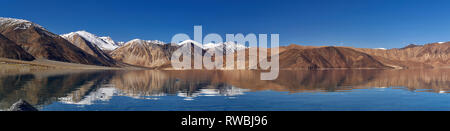 Grand miroir complet réflexions sur la surface de l'eau de la haute montagne du lac Pangong, un peu de neige sur les montagnes, photo panorama, Jammu-et-Ka Banque D'Images