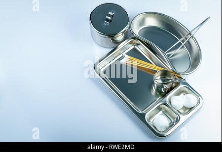 Vue de dessus de la plaie pansement et plaque en acier inoxydable, forceps, boules de coton, bâtonnets de coton, coupe l'iode, d'instruments contenant. L'offre médicale Banque D'Images