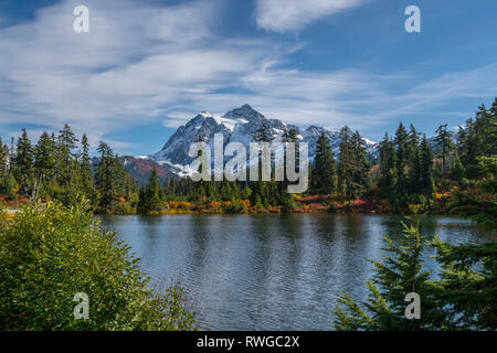 WASHINGTON - le Mont Shuksan se reflétant dans Picture Lake dans la zone de loisirs de Heather Meadows dans le nord de Cascades.les couleurs d'automne sont abondantes dans la végétation. Banque D'Images