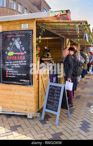 Les gens occupés à Wakefield Food, Drink & Rhubarb Festival 2019 marché en échange de la vente de bouteilles de gin - West Yorkshire, Angleterre, Royaume-Uni Banque D'Images