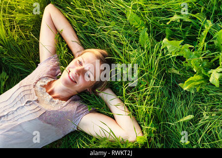 Femme couchée sur l'herbe dans la campagne Banque D'Images