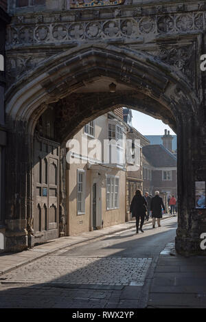 Salisbury, Wiltshire, Angleterre, Royaume-Uni. Mars 2019. Visiteurs en passant par la porte nord de la cathédrale de la ville en direction de la Grand-rue Fermer Banque D'Images