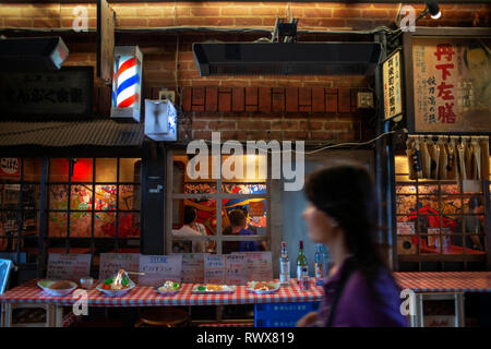 Un dîner sous la voie ferrée : la ruelle Yakitori, Tokyo Japon. Situé sous la voie ferrée à travers lequel la célèbre bullet trains empruntent ce sont al Banque D'Images