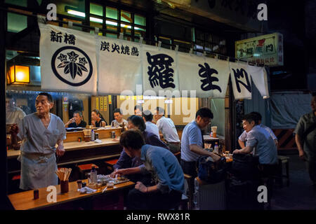 Un dîner sous la voie ferrée : la ruelle Yakitori, Tokyo Japon. Situé sous la voie ferrée à travers lequel la célèbre bullet trains empruntent ce sont al Banque D'Images