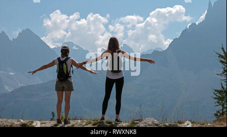 Les femelles les randonneurs de profiter de la vue sur les montagnes et les planeurs para sur la vallée de Chamonix, en France et en direction du Mont Blanc dans les Alpes françaises. Banque D'Images