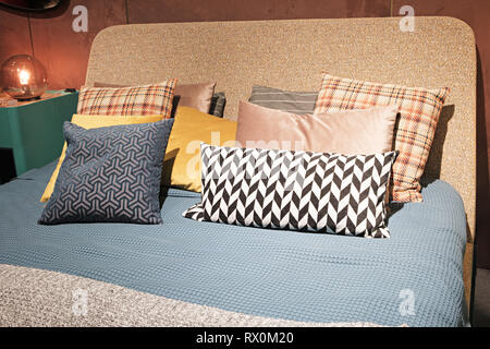 Chambre De luxe de style moderne et en gris, rose, brun et bleu, l'intérieur d'une chambre avec des coussins moelleux Banque D'Images