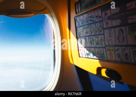 Vue de la fenêtre ouverte et à l'arrière de siège passager sur un avion dans l'air Banque D'Images