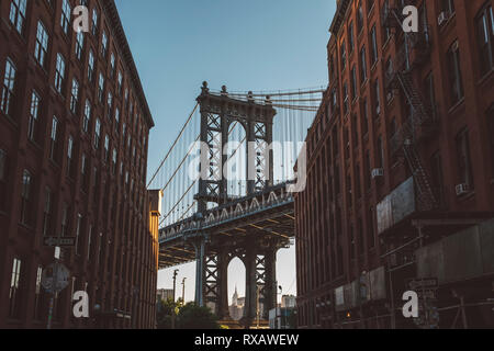Low angle view of buildings contre pont de Manhattan pendant le coucher du soleil Banque D'Images