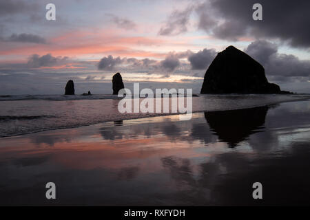 Haystack Rock et les aiguilles au coucher du soleil, Cannon Beach, Oregon Banque D'Images