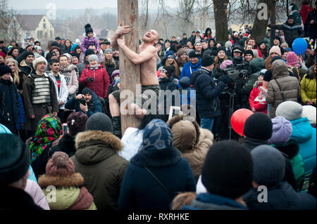 Tambov, Région de Tambov, en Russie. Mar 10, 2019. 10 mars 2019 dans le parc de la culture et des loisirs (Tambov, Russie) a tenu une maison de vacances de Maslenitsa. Pour les invités du festival a été préparé un concert, concours, spectacles, spectacle de feu. À la fin des vacances, la gravure traditionnelle de l'effigie de l'hiver (l'effigie de Maslenitsa) a eu lieu. C'est une ancienne tradition russe d'adieu à l'hiver et du printemps réunion. Dans les photo-un homme remonte la Maslenitsa pôle pour le prix Crédit : Demian Stringer/ZUMA/Alamy Fil Live News Banque D'Images