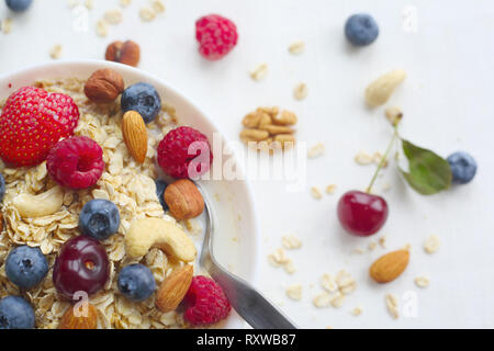 Bouillie d'avoine dans un bol garni de fruits frais et des céréales croustillantes Banque D'Images