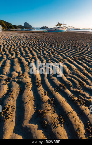 Bateau local sur la rive de la plage d'El Nido, dans l'île de Palawan, Philippines Banque D'Images