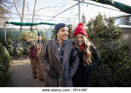 Heureux couple shopping pour arbre de Noël Marché de Noël