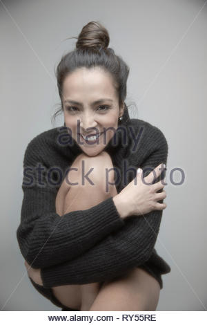 Portrait happy brunette woman in sweater
