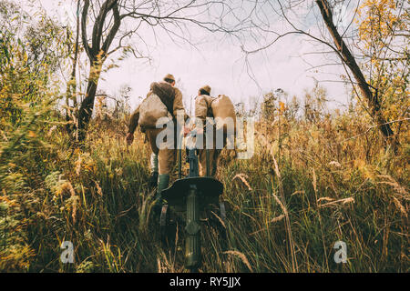 Reenactors habillés en soldats de l'Armée rouge soviétique russe de la Seconde Guerre mondiale la marche avec la mitrailleuse Maxim avec arme en automne Forêt Prairie Banque D'Images