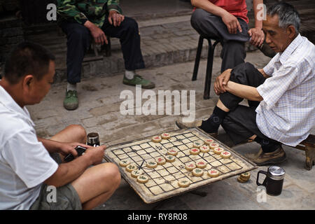 Les hommes chinois jouer Majong dans la rue, Ping Yao, Shanxi, Chine Banque D'Images