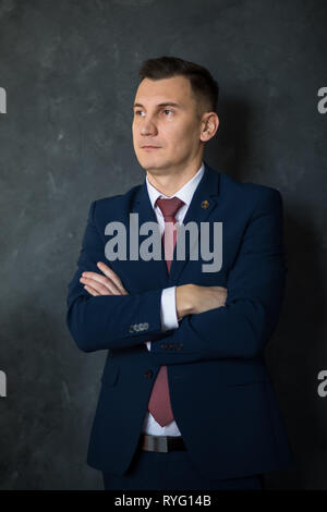 Portrait de jeune homme intelligent avocat debout les bras croisés dans l'intérieur du bâtiment de bureaux modernes, les hommes vêtus de l'employé de banque Banque D'Images