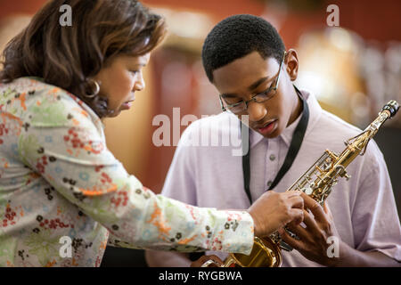 Adolescent apprendre à jouer du saxophone. Banque D'Images