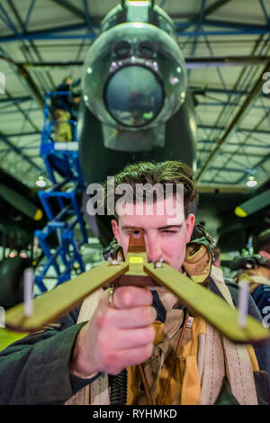 Londres, Royaume-Uni. 14 mars, 2019. A la reconstitution médiévale avec une réplique de la dispositif de visée Dambuster en face de la Lancaster - Histoires immersive de Réalité Virtuelle Dambusters : l'expérience. L'occasion de revenir dans le temps pour les premières heures du 17 mai 1943 et à bord d'Avro Lancaster G-George à rejoindre les briseurs de barrages sur leur mission légendaire. En utilisant les dernières technologies de réalité virtuelle et haptique, conjointement avec un 1:1 les loisirs de l'intérieur de l'emblématique bombardier Avro Lancaster. Crédit : Guy Bell/Alamy Live News Crédit : Guy Bell/Alamy Live News Banque D'Images