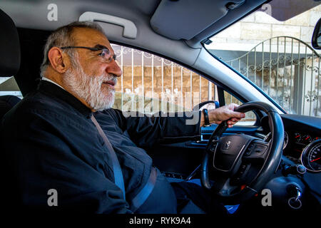 (Grec melkite catholique) prêtre Émile Shoufani, au volant de sa voiture. Banque D'Images