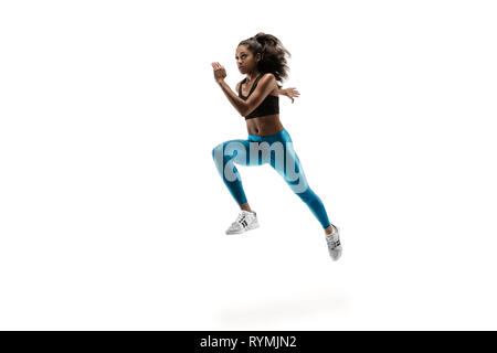 Young African woman isolated on white background studio. L'une coureuse ou du jogging. Silhouette d'athlète jogging Banque D'Images