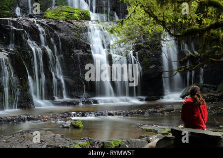 Purakaunui Falls, la Nouvelle-Zélande, Catlins, avec Girl in red jacket Banque D'Images