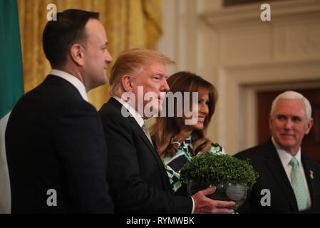 Taoiseach Leo Varadkar nous présente le Président Donald Trump avec un bol de Shamrock, regardée par Melania Trump et vice-président américain Mike Pence, au cours d'une célébration de la St Patrick Accueil et présentation Shamrock cérémonie à la Maison Blanche à Washington D.C. Banque D'Images