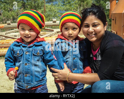 Thimpu / Bhoutan - 17 mai 2013 : une chambre enfants bhoutanais en usure colorée qui pose pour une photographie avec une dame Banque D'Images