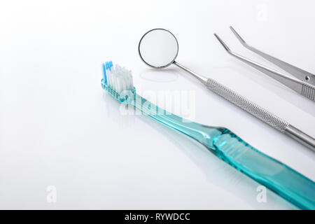 Dentiste blanc table avec outils et le nettoyage des dents concept. Composition horizontale. Elevated view Banque D'Images