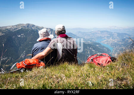 Vallée de l'Ubaye (sud-est de la France). Couple de randonneurs d'admirer les montagnes et le lac de Serre-Ponçon Banque D'Images