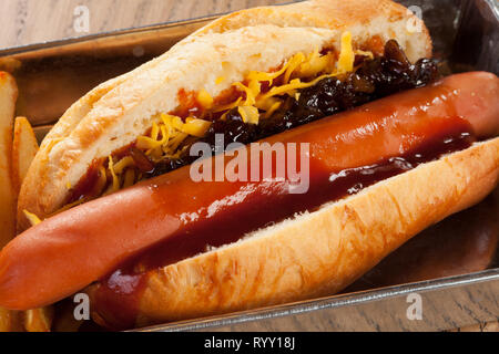 Santwich hot-dog avec frites et salade servie dans un plat rectangulaire en aluminium Banque D'Images