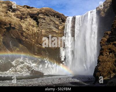 Or, à la fin de l'arc en ciel. - Skogafoss, cascade de 60 mètres de haut dans le sud de l'Islande. Banque D'Images