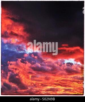 Ciel rouge avec des nuages au coucher du soleil Banque D'Images