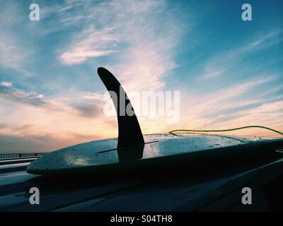 Surf sur un fourgon au coucher du soleil Banque D'Images