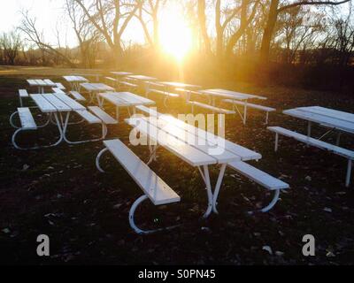 Tables de pique-nique au coucher du soleil dans un parc de la ville, l'ouest du Texas. Banque D'Images