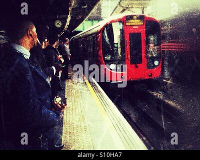 Les banlieusards attendre sur un tube de Londres Banque D'Images