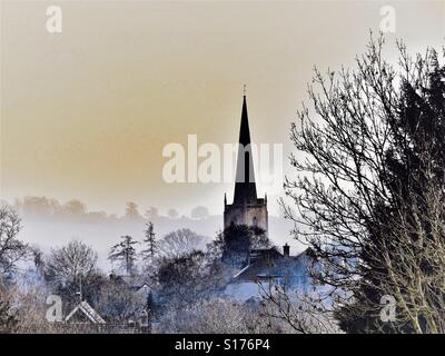 Le matin d'hiver de Cotswold. L'église du village dans la brume. Froid mais accueillant. Banque D'Images